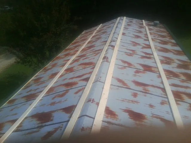 Rusted metal roof panels with new wood purlins before replacement — Storm Damage Roof Repair in Madison by Roofing Brothers